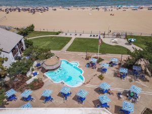 A view of an outdoor pool and beach from above.