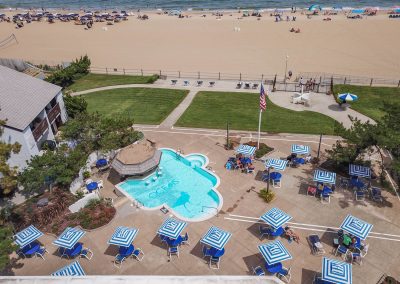 A view of an outdoor pool and beach from above.