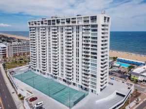 A large white building with many windows and balconies.