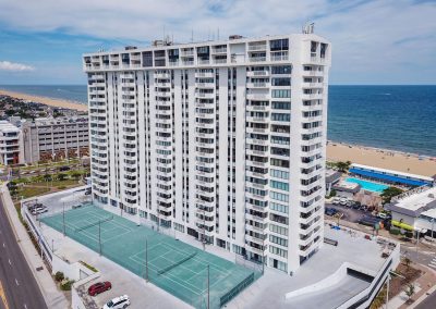 A large white building with many windows and balconies.