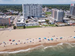 An aerial view of a beach with many umbrellas.