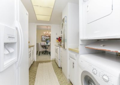 A kitchen with white appliances and cabinets in it