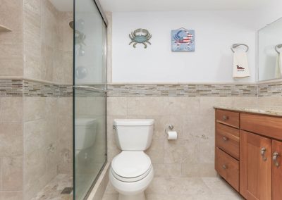 A bathroom with a toilet and shower in it