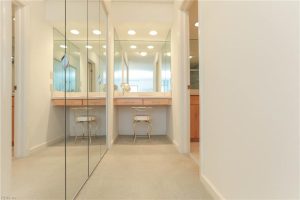 A bathroom with two sinks and mirrors in it