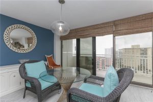 A living room with two chairs and a glass table