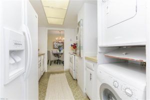 A kitchen with white appliances and cabinets in it