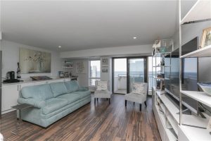 A living room with hardwood floors and a couch.