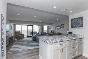 A kitchen with a large couch and living room.