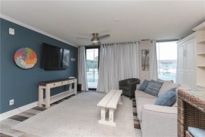 A living room with a couch, table and television.