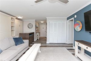 A living room with white furniture and blue walls.