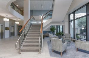 A large lobby with stairs and chairs in it