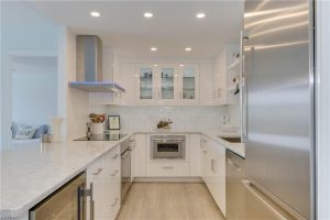 A kitchen with white cabinets and stainless steel appliances.