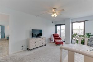 A living room with a television and chair