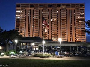 A large building with an american flag on the top of it.