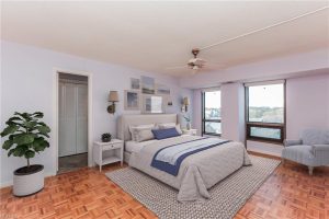 A bedroom with a large bed and a window.