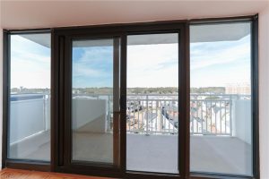 A large sliding glass door with a view of the ocean.