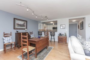 A living room with hard wood floors and furniture.