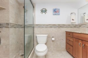 A bathroom with a toilet and shower in it