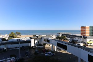 A view of the ocean from an apartment building.